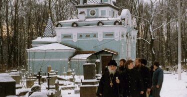 Archbishop Lazar visits St. Xenia's chapel on the Smolensk cemetery in St. Petersburg. C. 1991